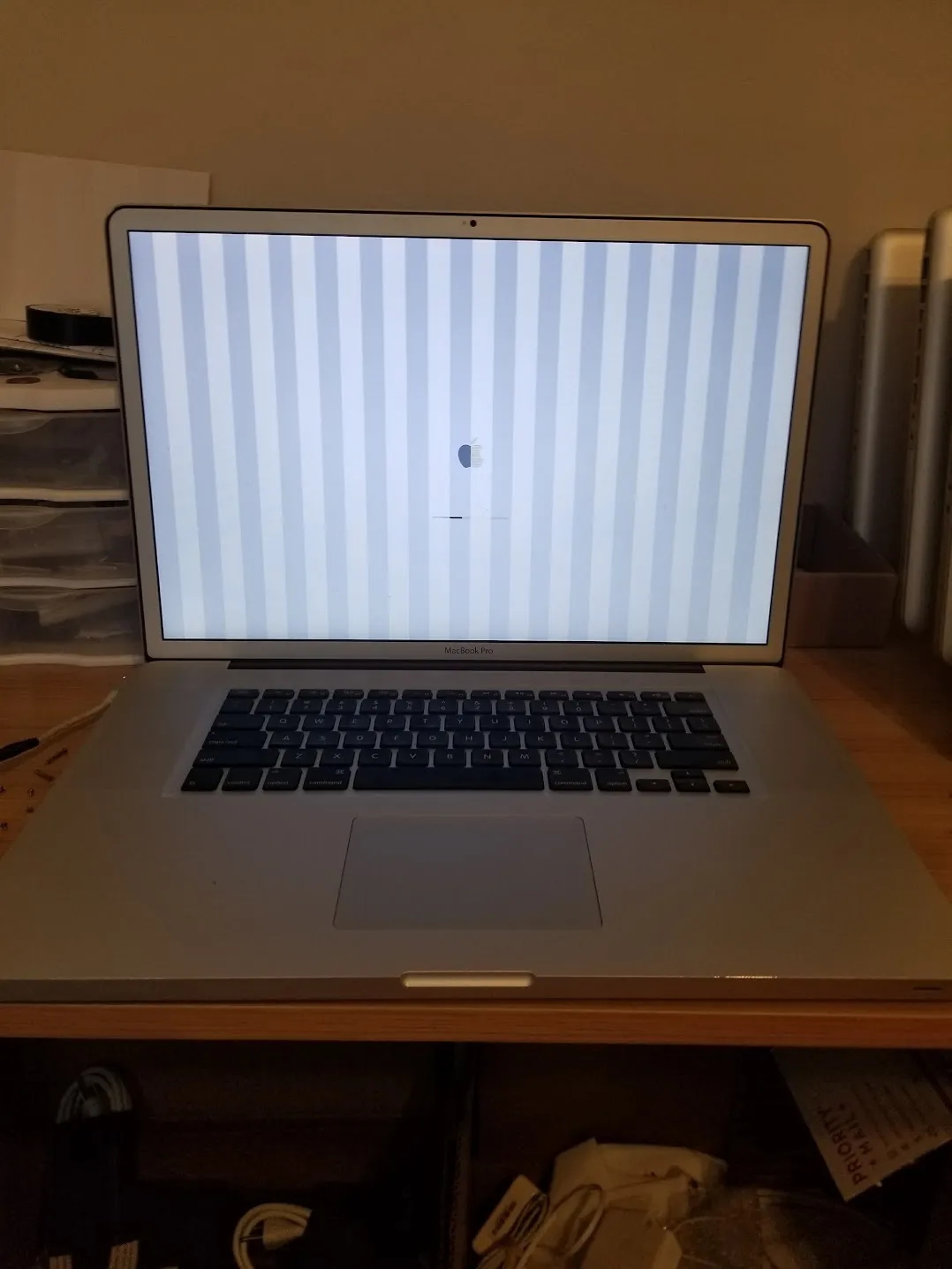 MacBook Pro screen showing vertical striped artifacts from a GPU failure