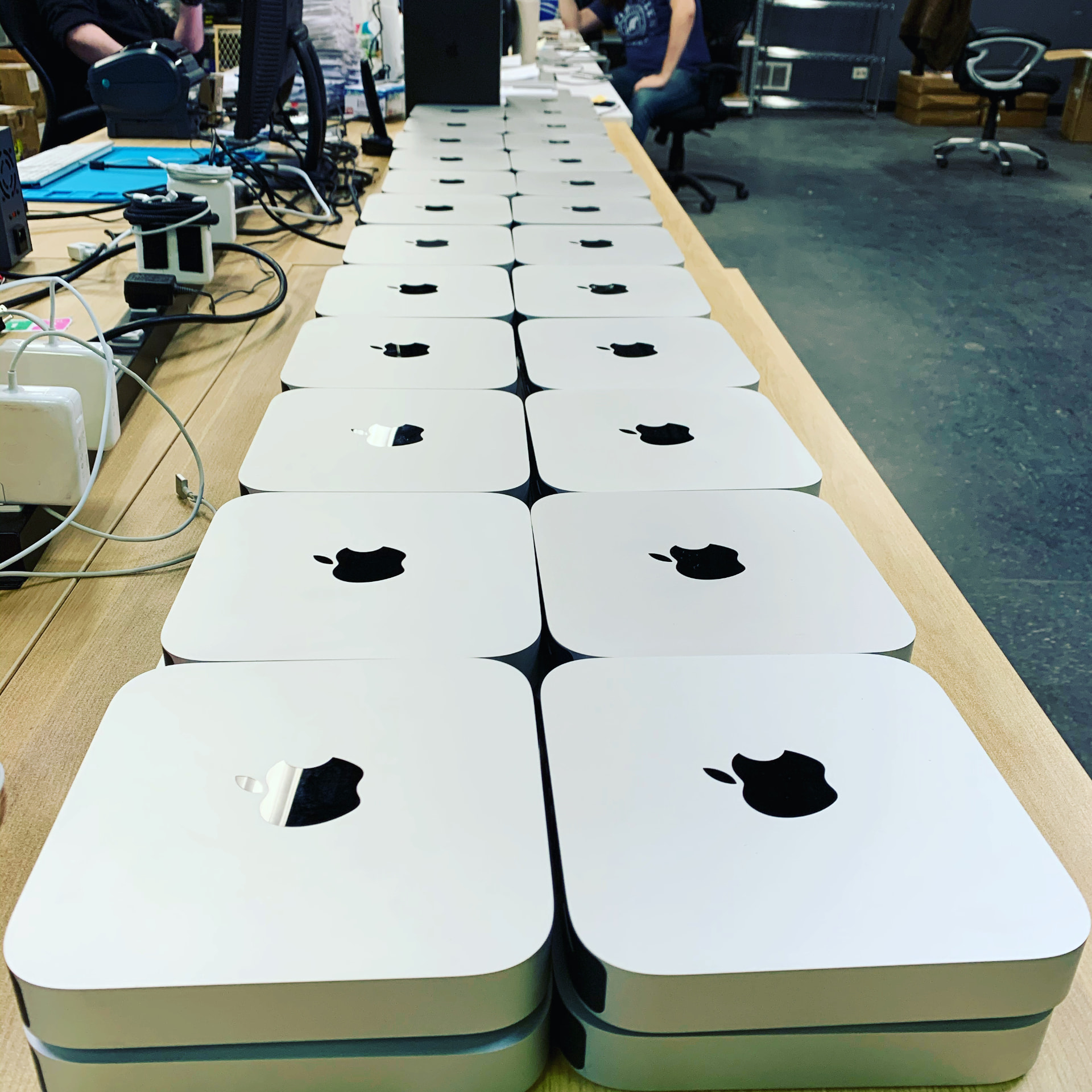 Mac minis lined up on a repair bench during the same period