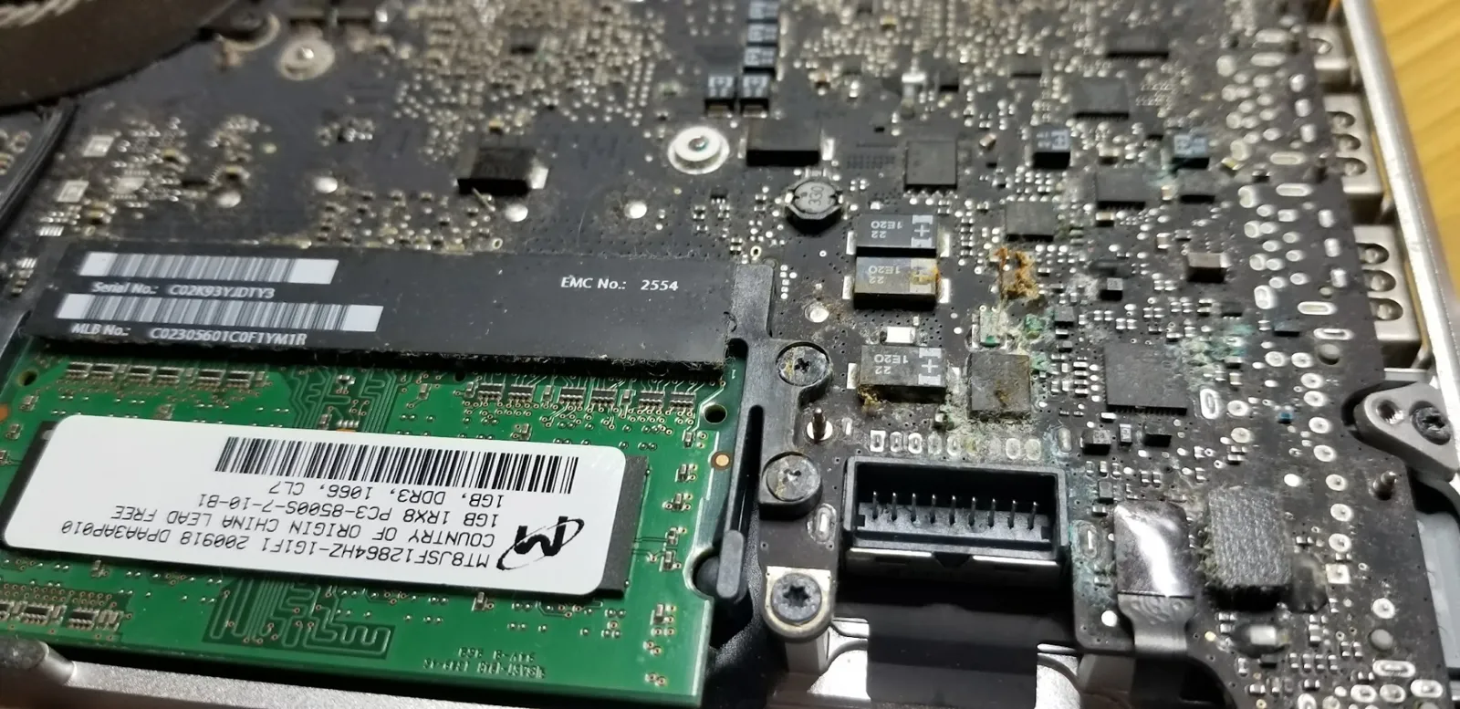Close view of a Mac logic board with liquid damage