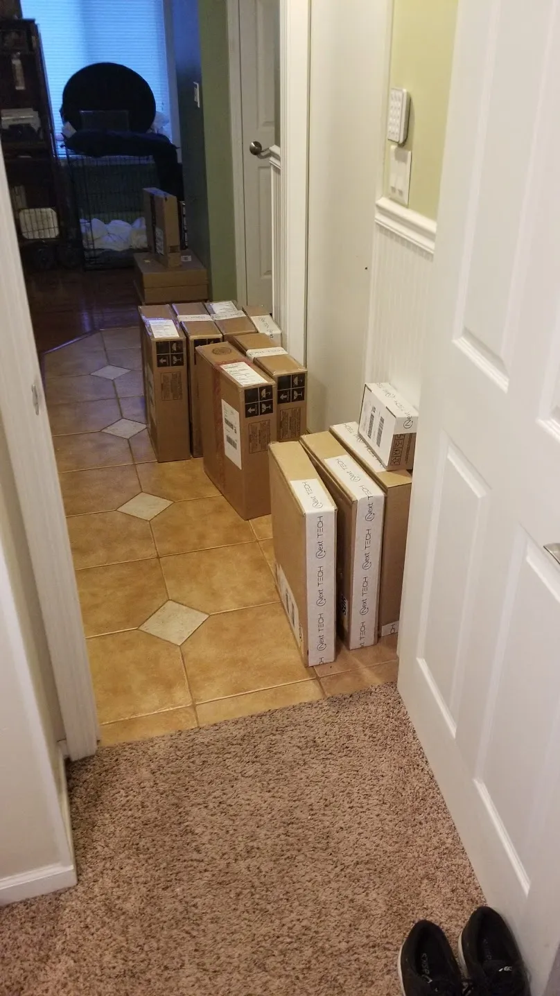 Boxed orders lined up in a hallway by the door of the Glendale Heights duplex