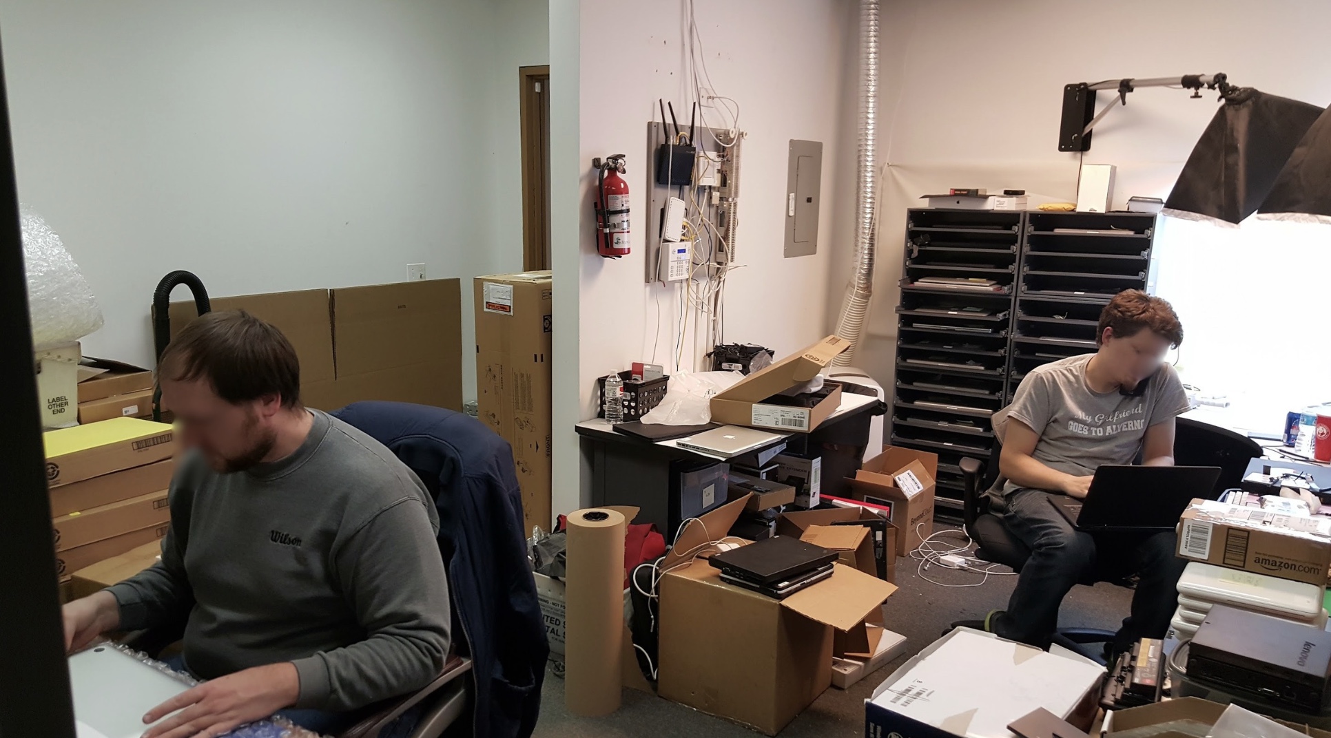 Archival photo of the early TechGator office with desks, monitors, and boxes of inventory