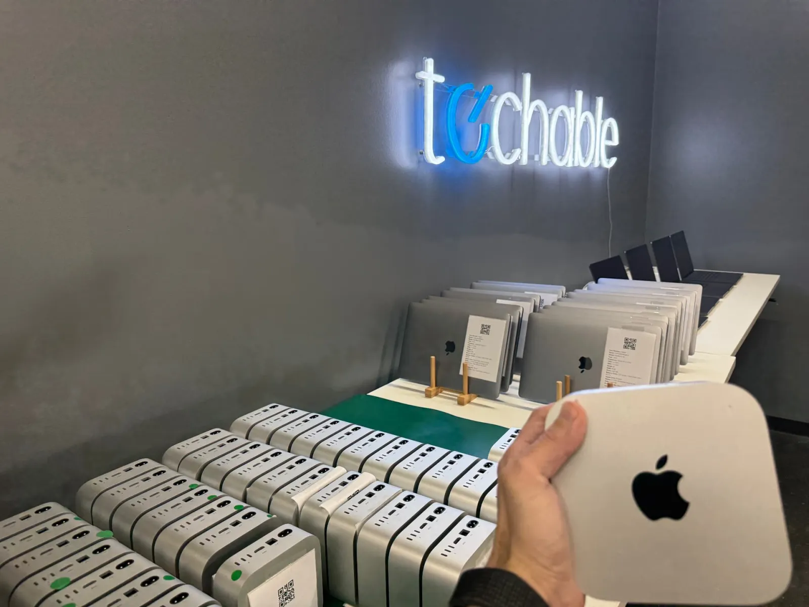 Mac minis and MacBooks lined up for processing at Techable