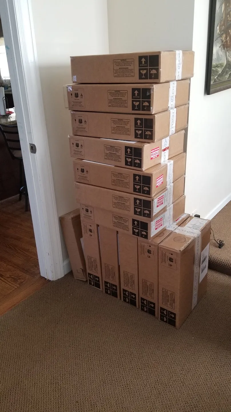 Stack of boxed orders waiting to ship inside the Elk Grove Village house
