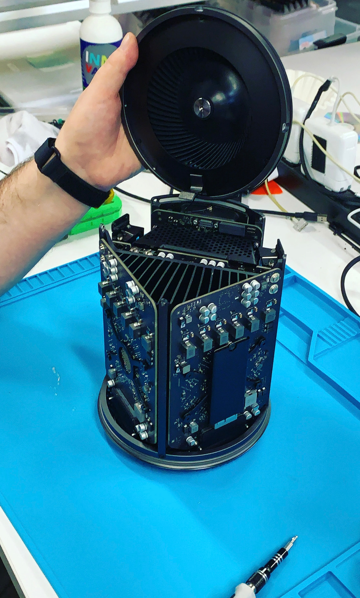 An opened Mac Pro on a repair bench during configuration work